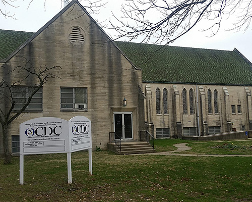 exterior image of a church with an Omega CDC sign in front